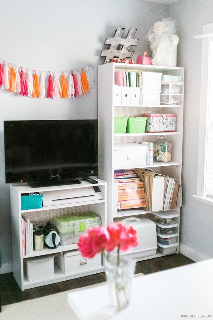 Add fabric backing to decorate inexpensive shelving when organizing and decorating a craft room