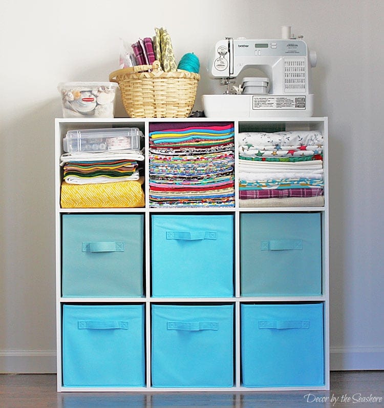 9 cubes (3x3 layout) holding various craft supplies (six cubes hold blue storage baskets)