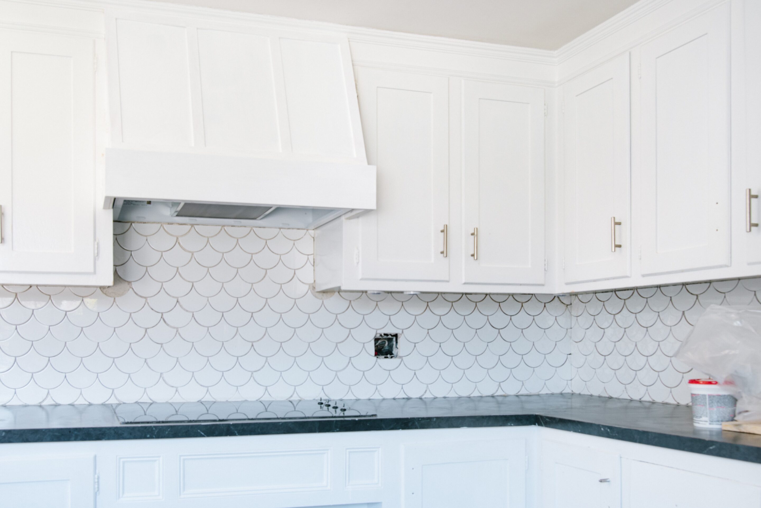 Range hood cover just built at home with white paint and plywood.