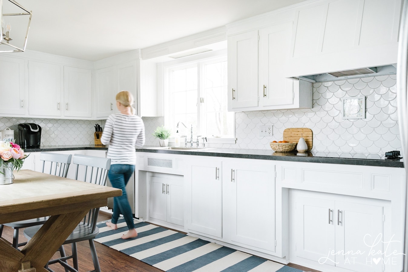 woman walking across kitchen runner