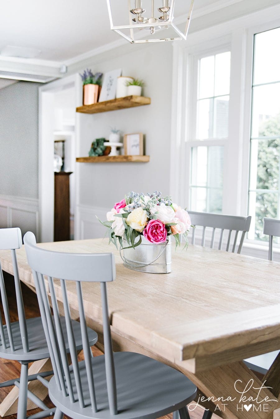 kitchen table with gray chairs and flower arrangement