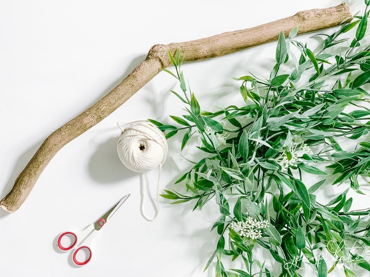 Branch, greenery, white twine and scissors