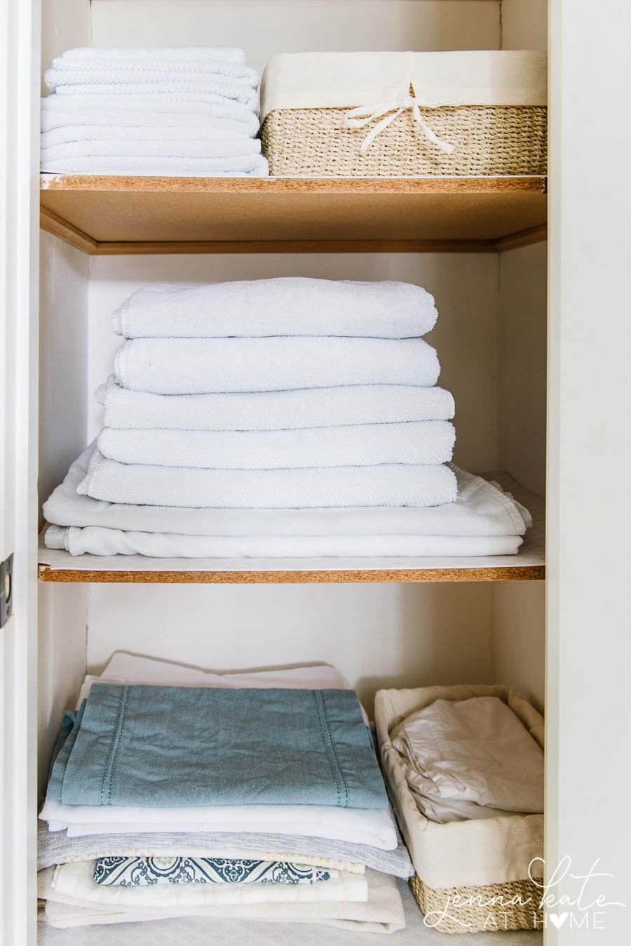 A stack of towels on a shelf of the linen closet