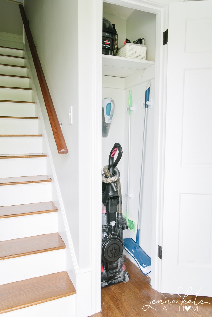 Broom closet with new shelf on top (now painted white) and clips to hang mops and brooms on the wall