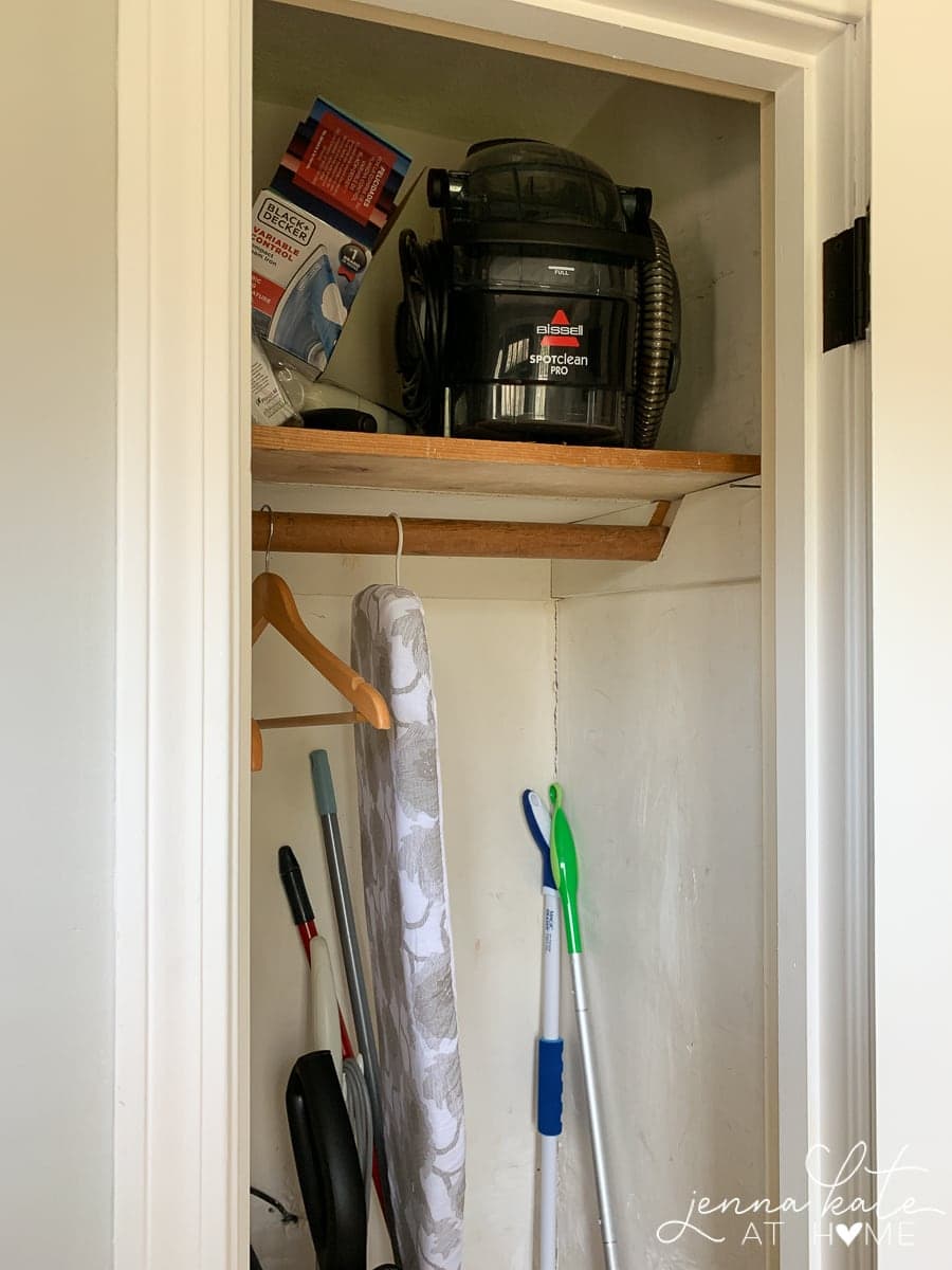 An upper shelf now added to the broom closet, holding parts of a vacuum