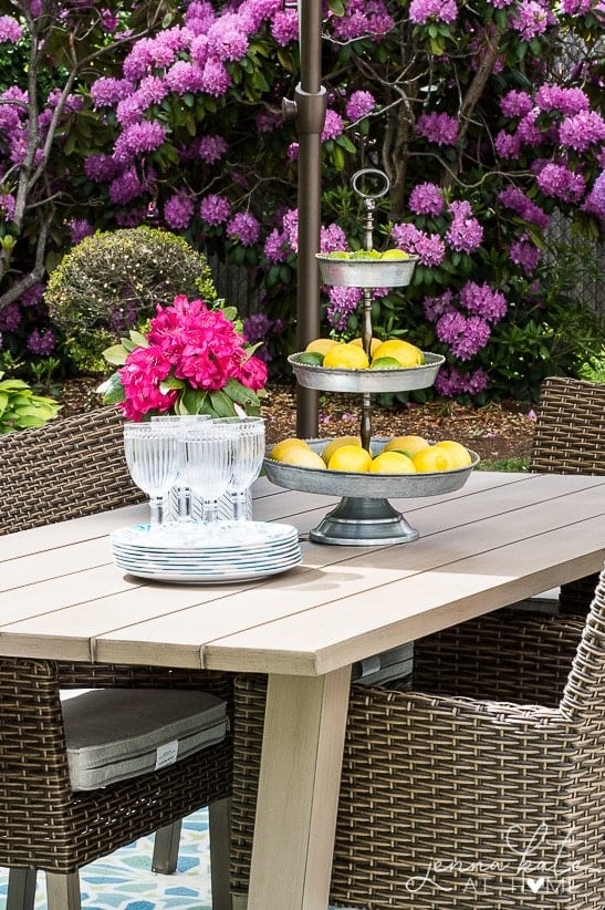 Outdoor dining area with lemons, plates, and cups. 