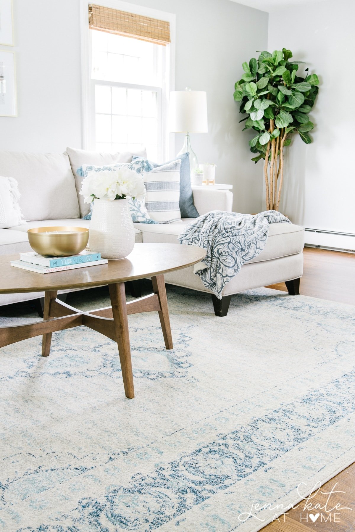 Living room with couch and coffee table with summer themed throw pillows