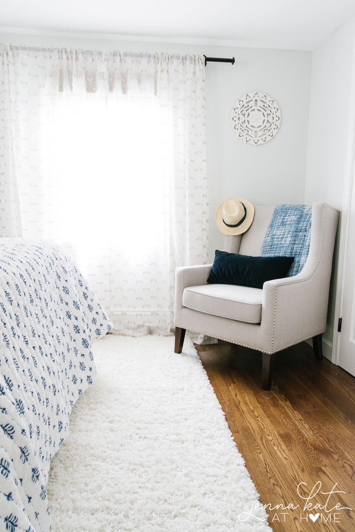 A bedroom with a chair in the corner