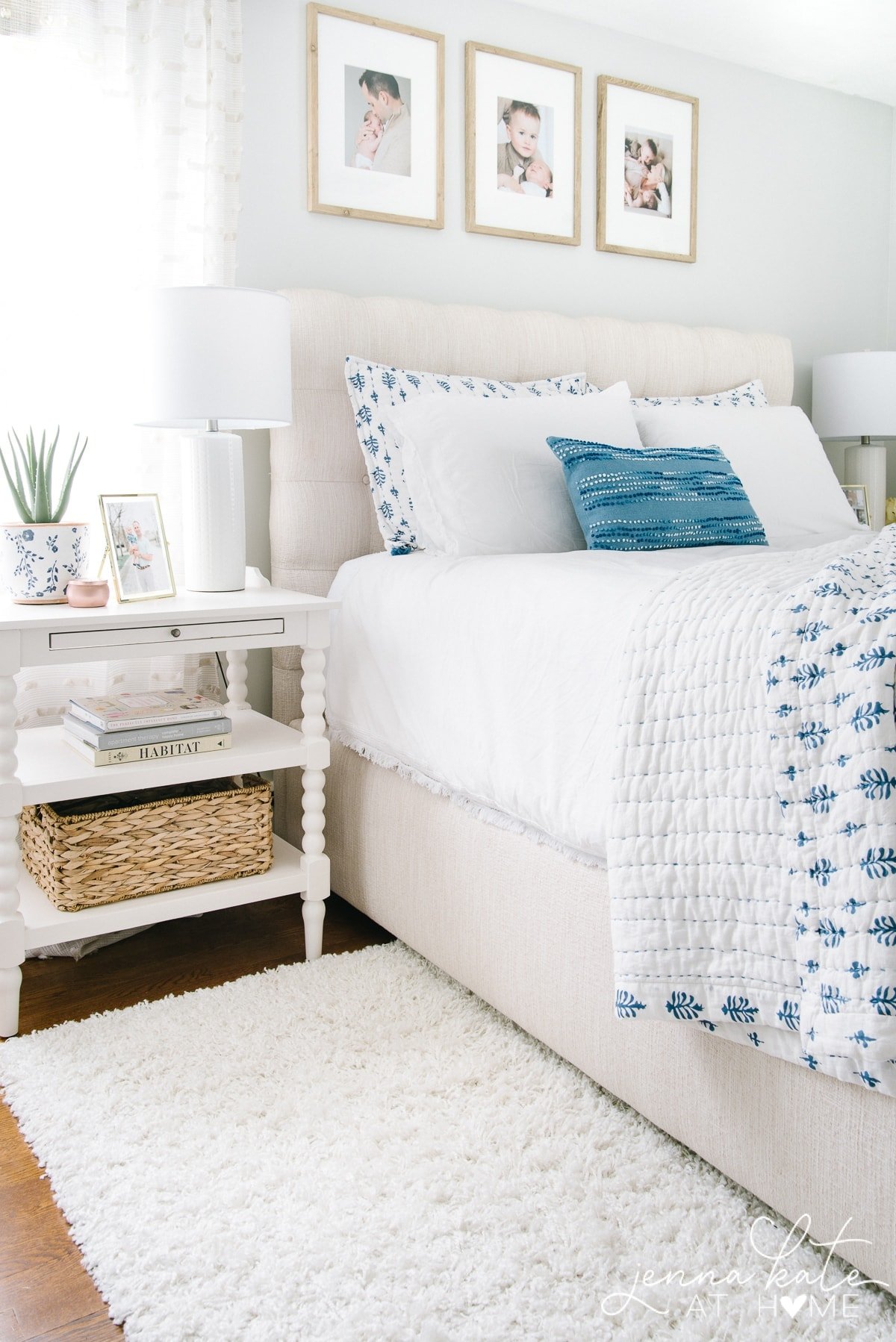 modern coastal style bedroom with linen upholstered bed, white nightstands and white lamps.