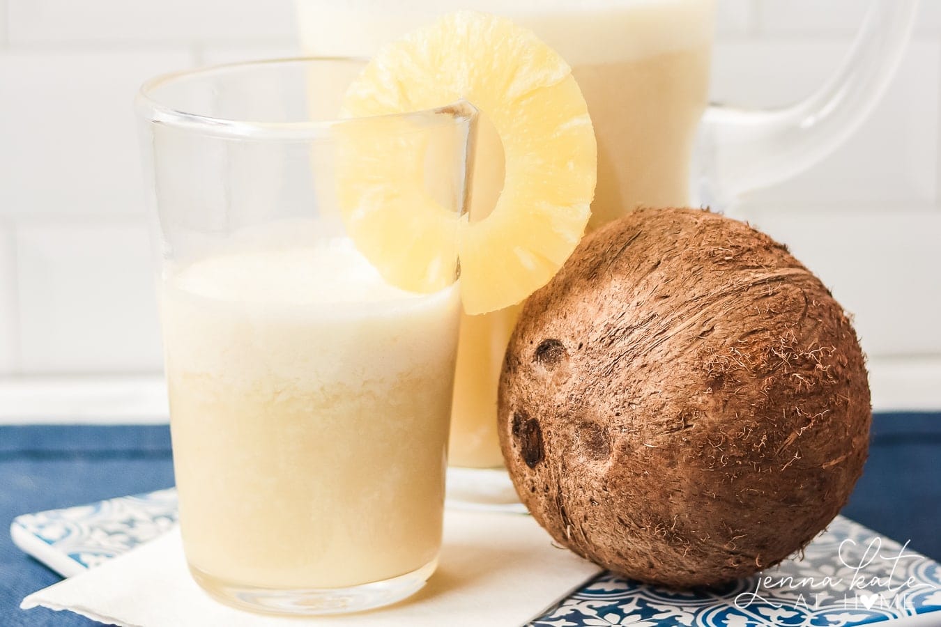 pina colada agua fresca with a coconut and pineapple slice