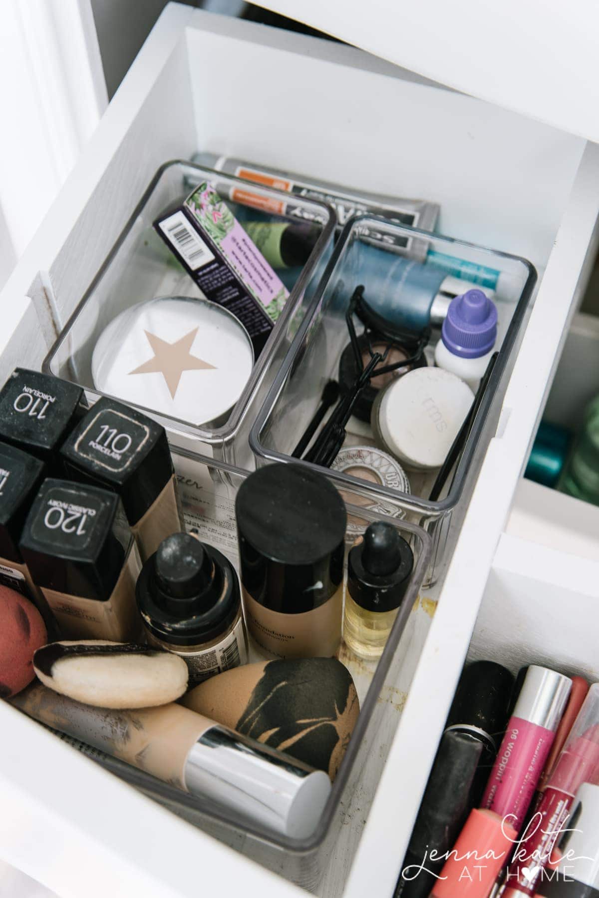 a bathroom drawer full of various makeup products