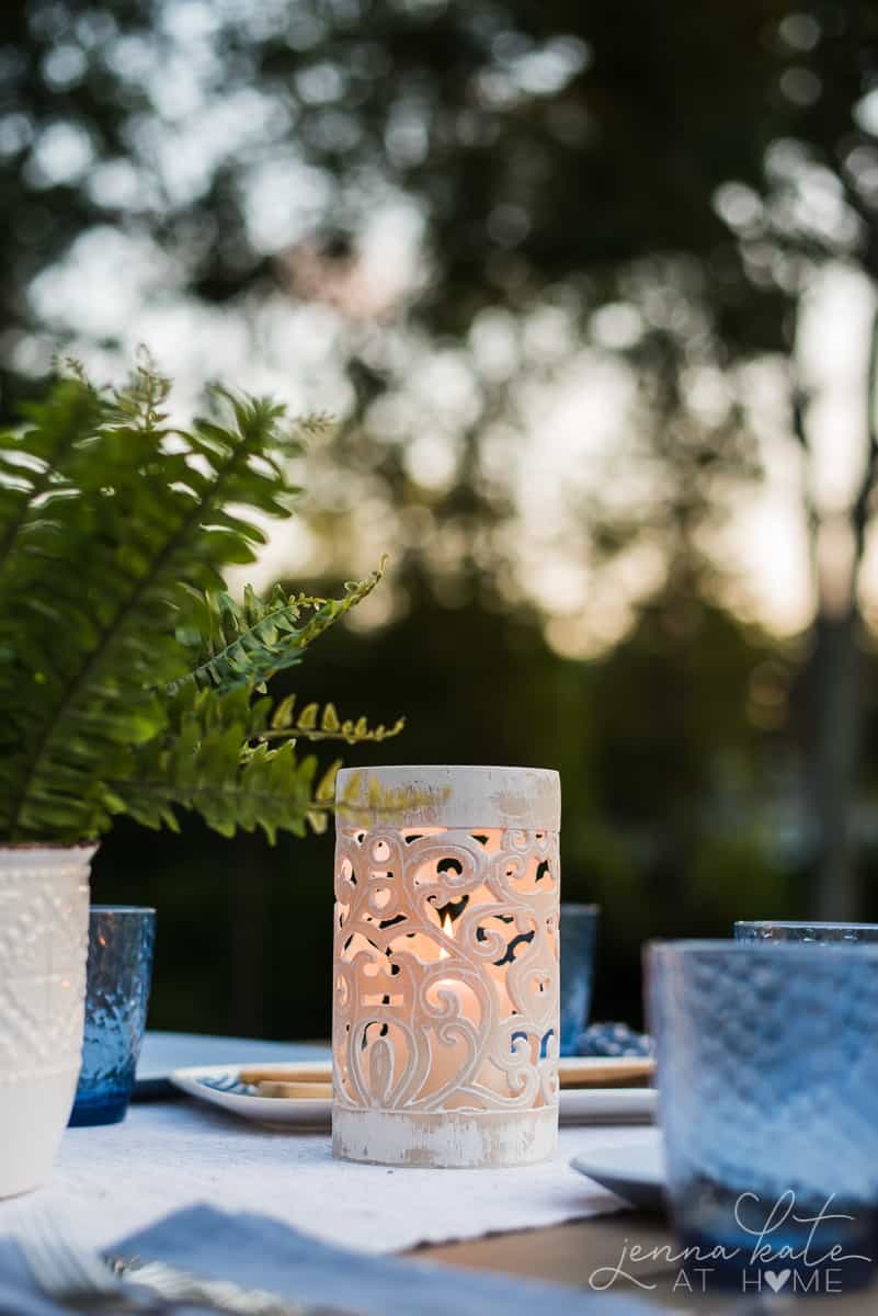 These coastal style candle lanters give our backyard patio dining table a warm, soft glow