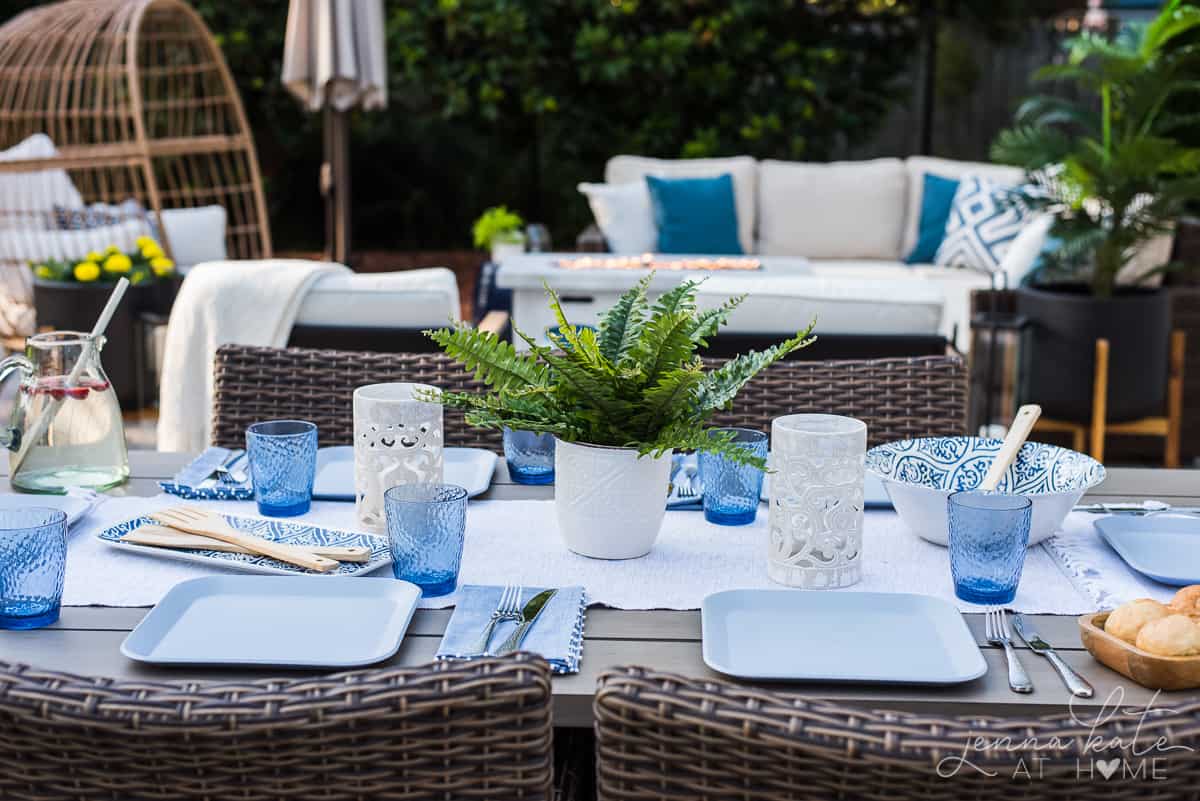 Blue and white drinkware and table settings give this outdoor patio table the coastal inspired look we were going for