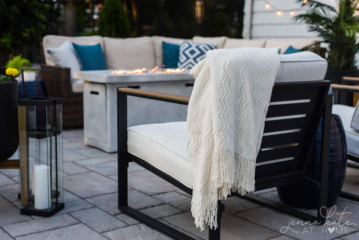 Ourdoor patio furniture with coastal colors and linens make a comfortable seating area