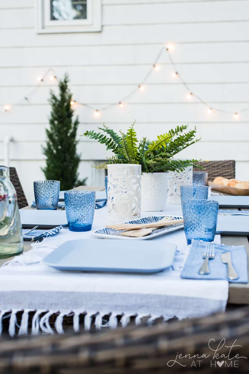 Modern coastal inspired table settings make our outdoor patio dining table a welcoming and colorful spot to gather