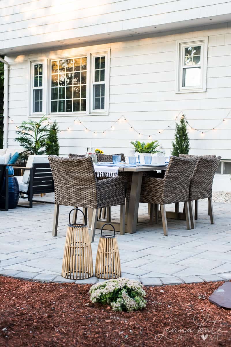 A backyard patio dining area with strings of fairy lights for soft, warm lighting