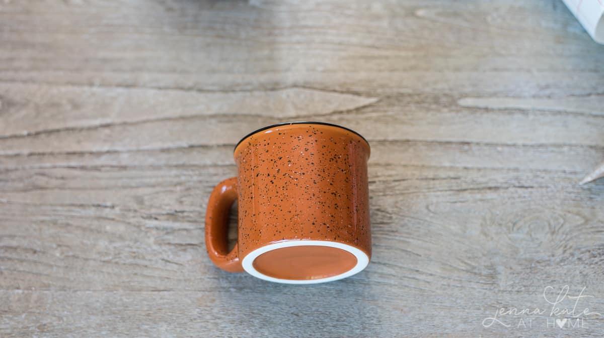 Plain, ceramic mug awaiting transfer of vinyl lettering