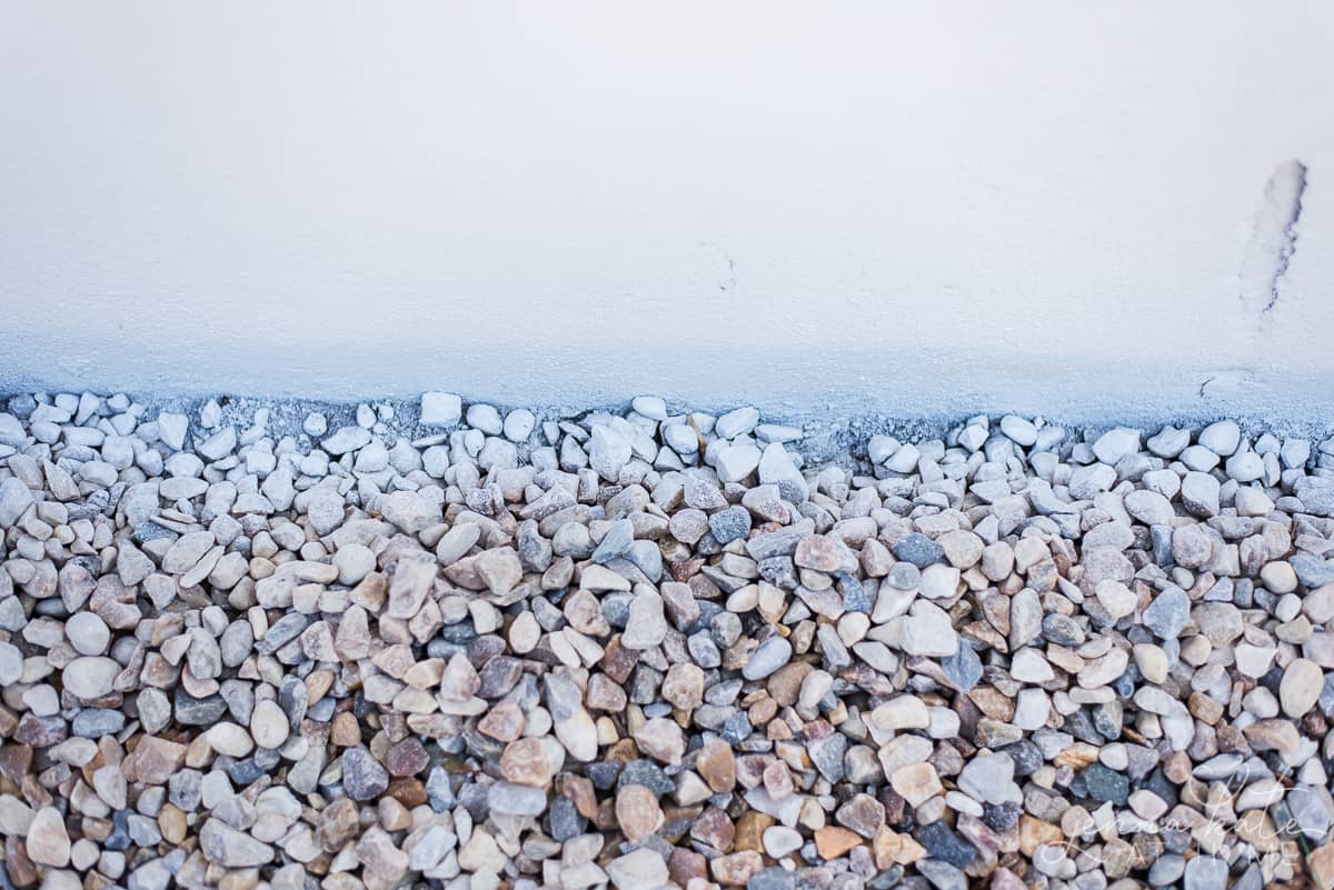 Our home's foundation painted white, and only got a little overspray on the rocks surrounding the foundation