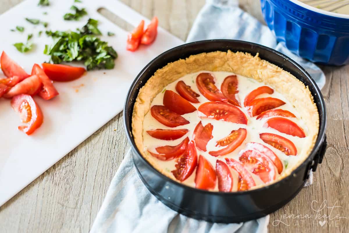 This tomato pie is a homemade pie crust filled with a creamy parmesan buttermilk custard and juicy, ripe tomato slices