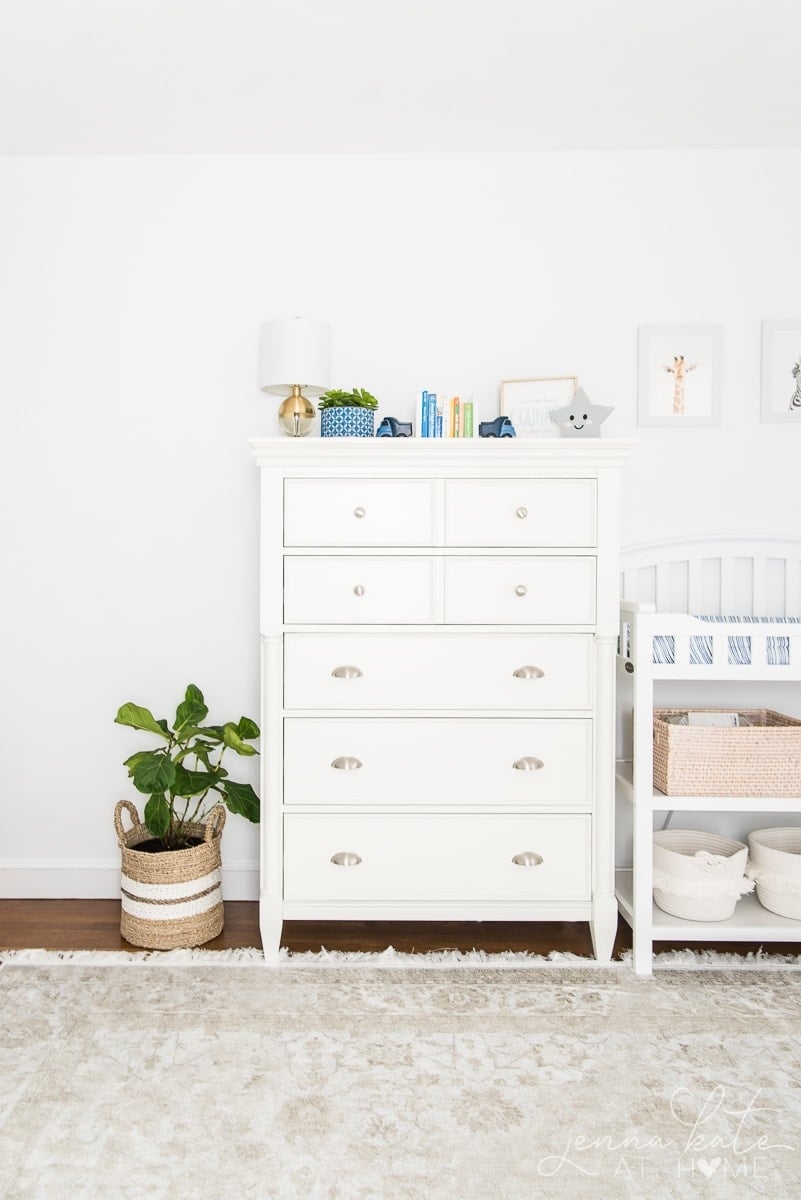 Nursery painted bright white is a great light reflecting color for dark rooms