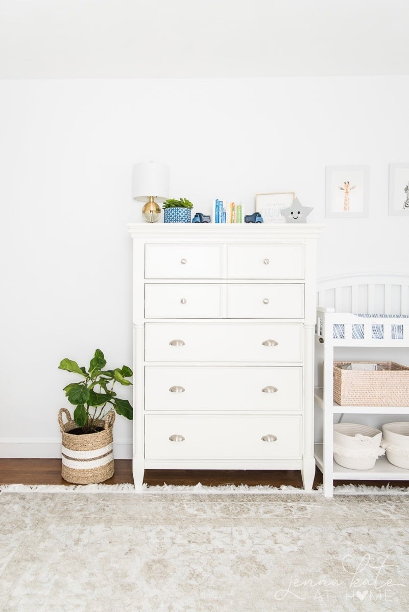 White dresser with books and decorative objects on top