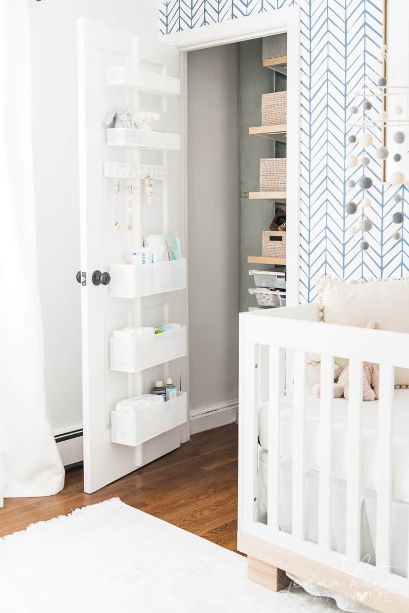 Organized nursery closet with storage behind the door