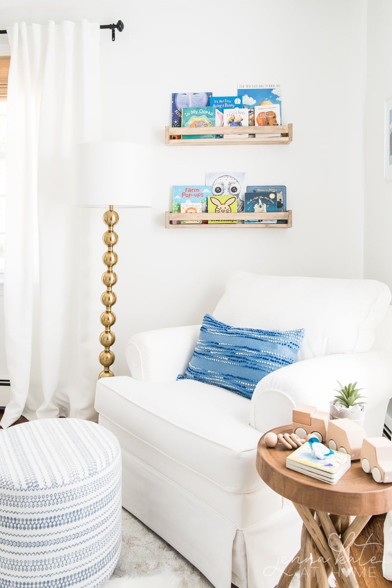 Bookshelves hanging on the wall next to the rocking chair