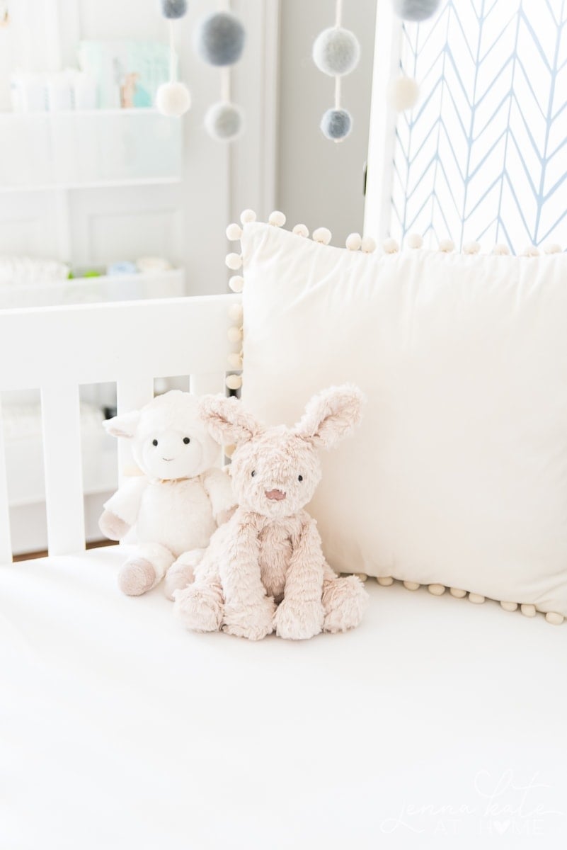 A teddy bear sitting on top of a crib