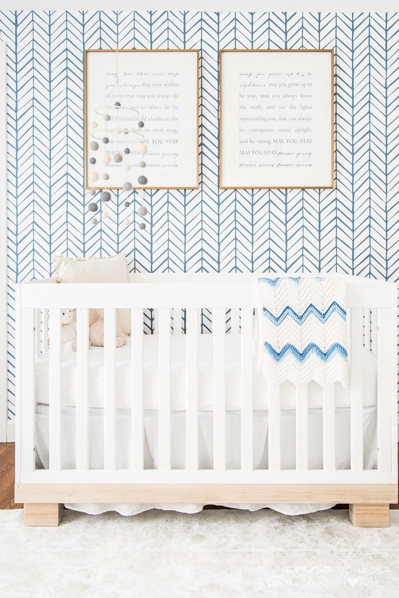 Nursery with serena and lily wallpaper and white crib