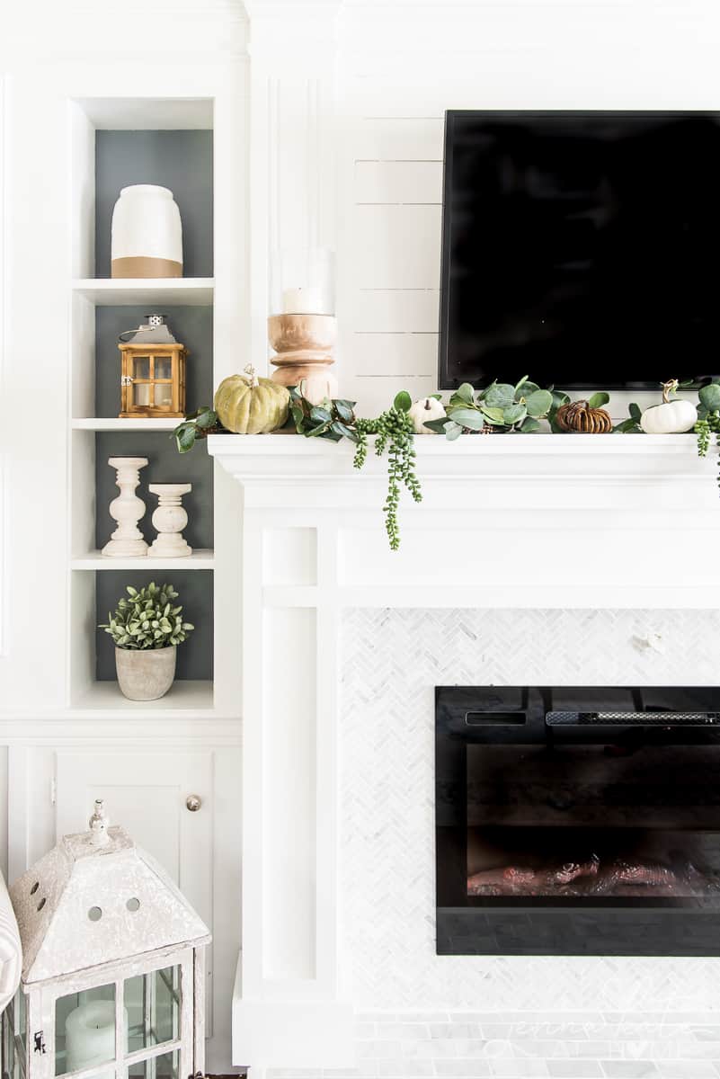 Left side of the mantel with a candle holder and garland