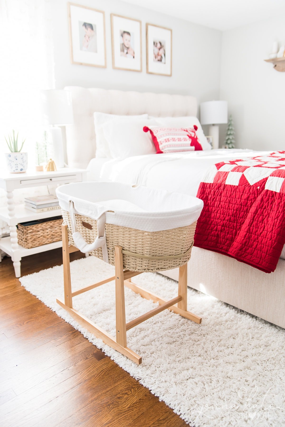 Bedroom decorated for Christmas with a bassinet next to the bed