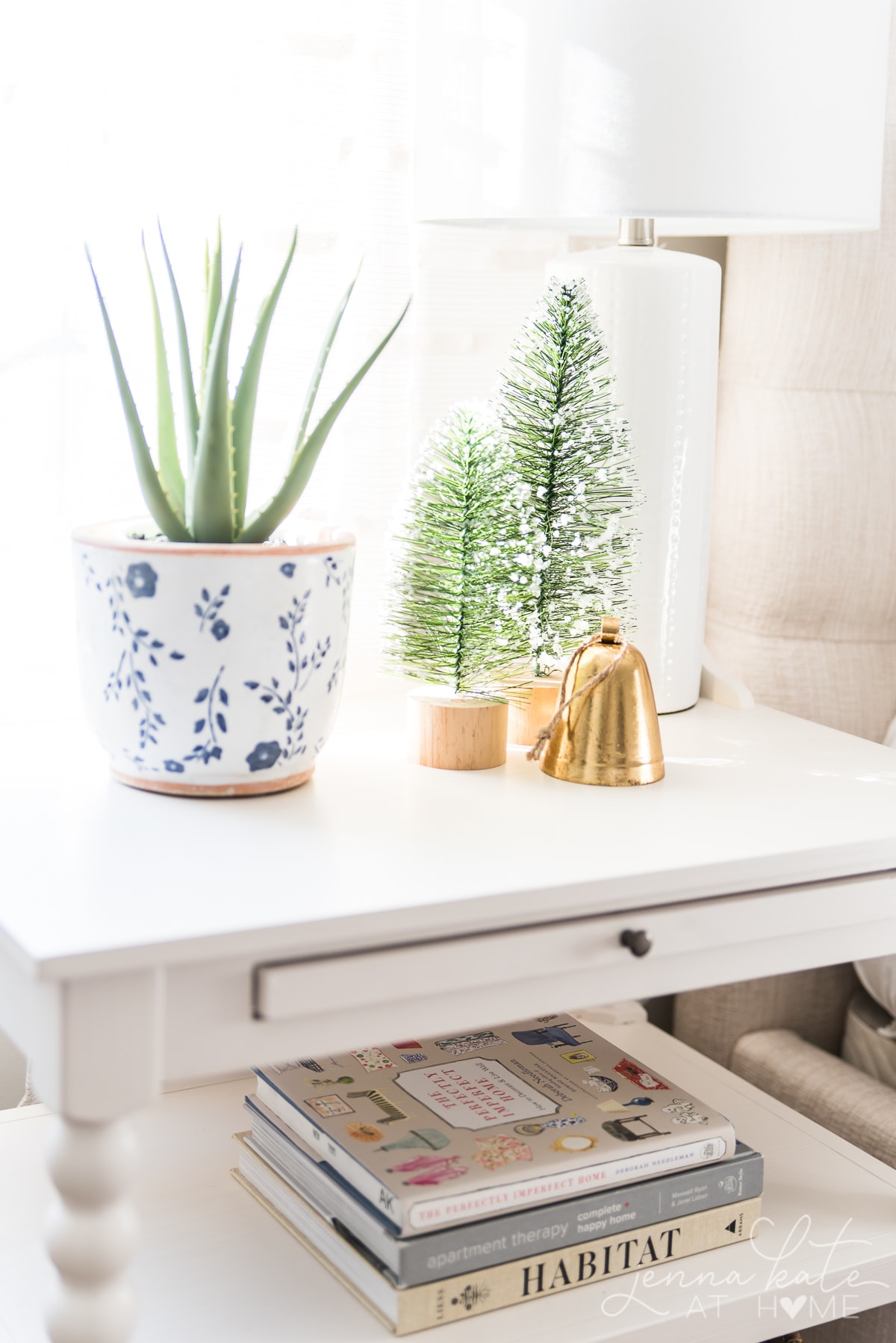 Bottle brush trees and a bell on the bedroom nightstand