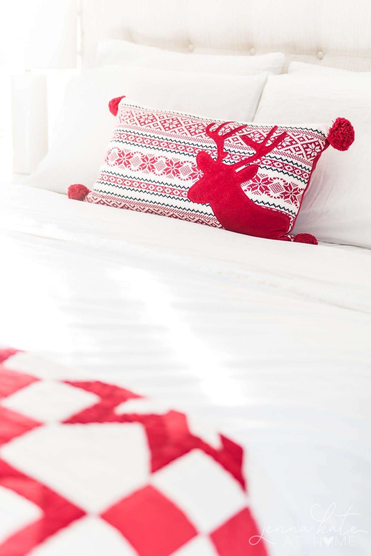 Red festive throw pillow on the bed