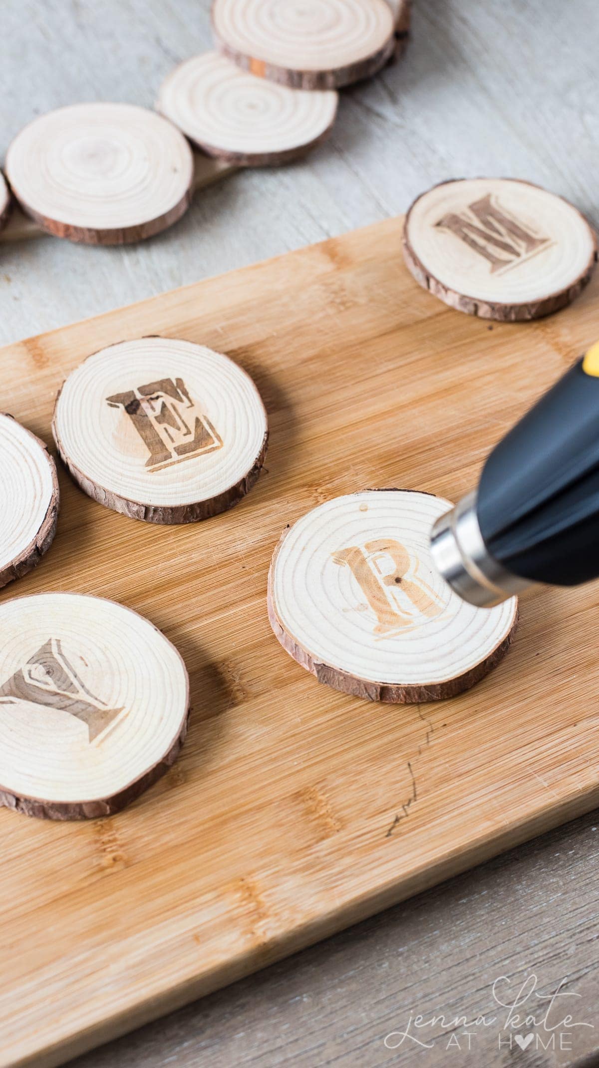 Using the heat gun to burn the stencil imprint into the wood