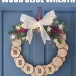 Wood slice holiday wreath hung on a blue door