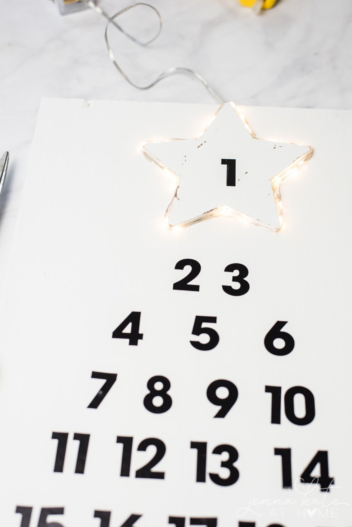 Bright twinkling lights adding an extra Christmas touch to this DIY wooden advent calendar