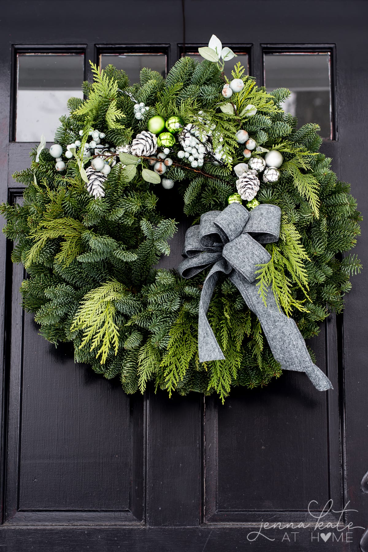 Evergreen Christmas wreath with a gray bow