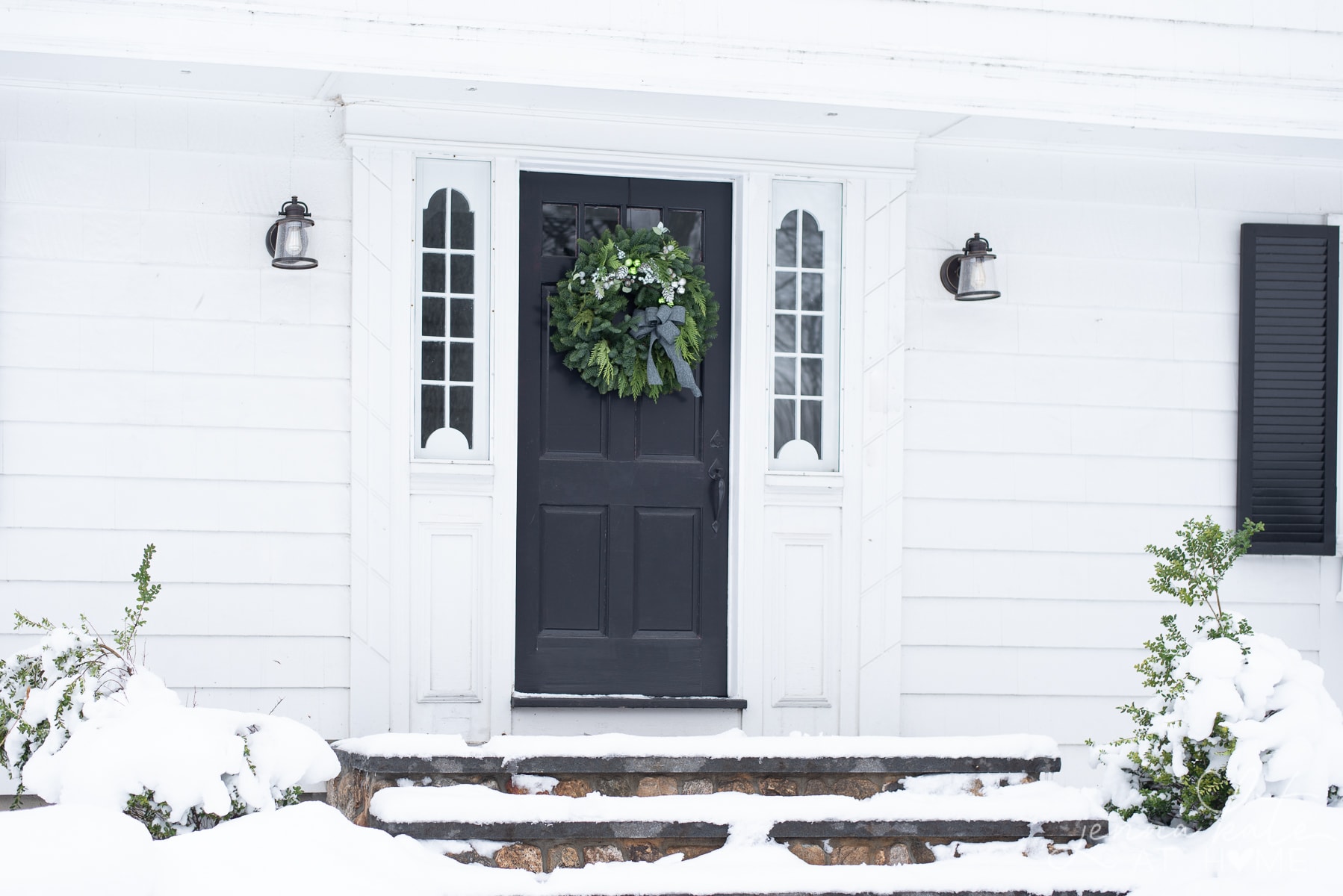 Front entryway with the steps covered in snow