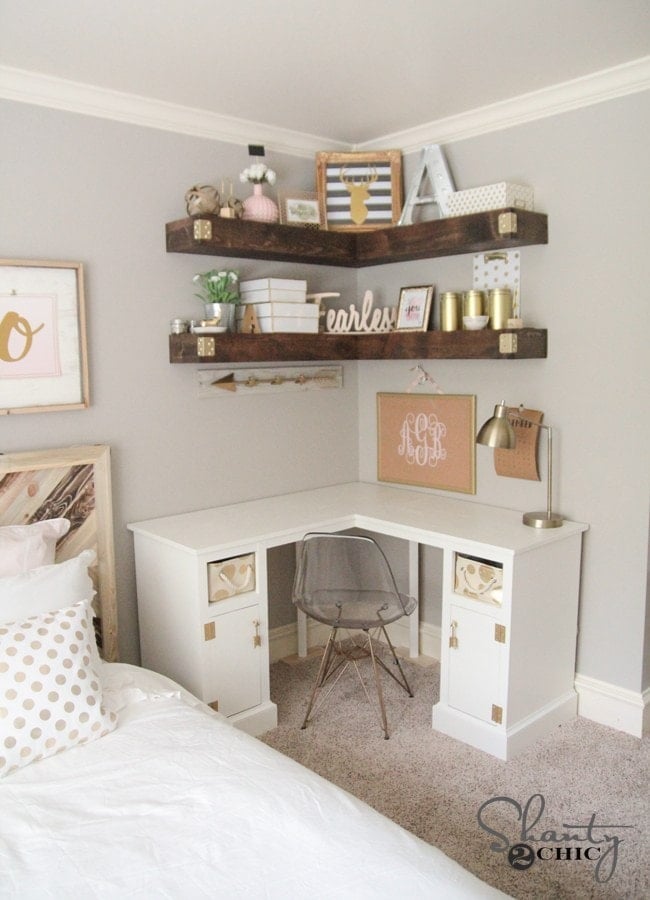 Corner shelves in a bedroom office define the space