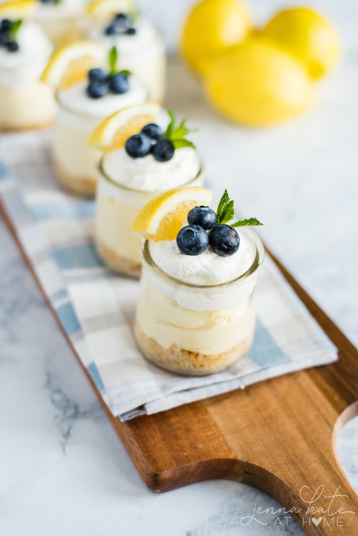 Lemon Mousse Parfaits with blueberries, fresh cream and a sprig of fresh mint