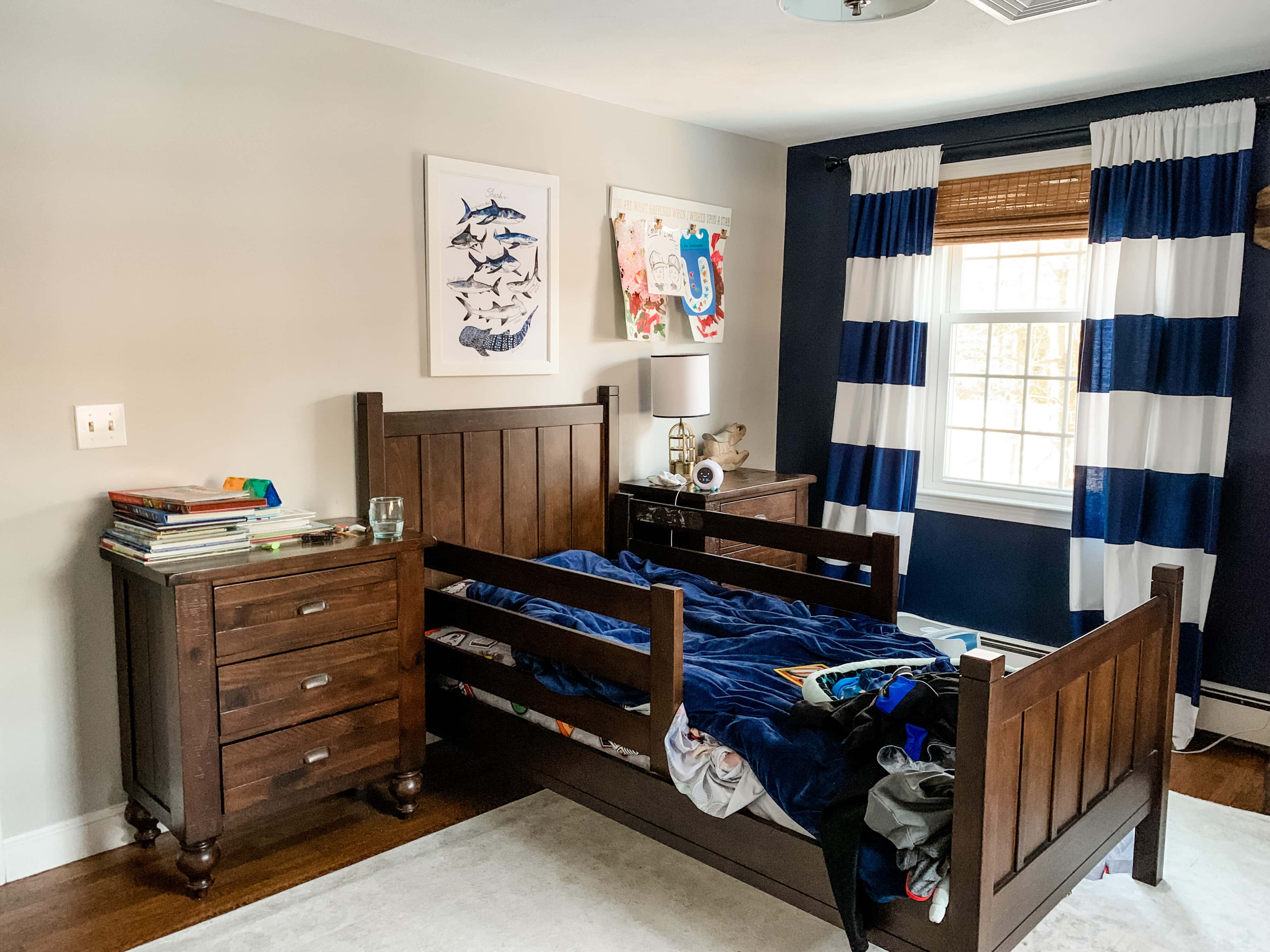 Toddler Bedroom Before - gray walls, navy accent wall and dark wood furniture