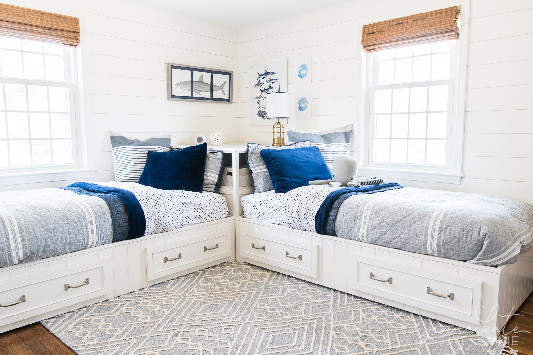 shared boy bedroom with two twin beds with navy and gray bedding