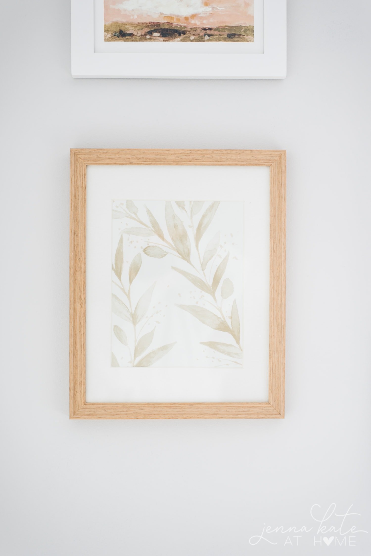 Scrap of floral wallpaper framed in a natural wood frame