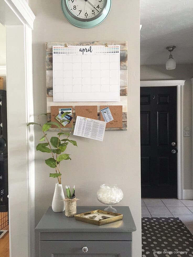 DIY shiplap command center on wall with cork pinboards and calendar