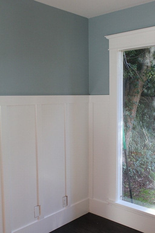 Blue gray with a hint of green above white wainscoting