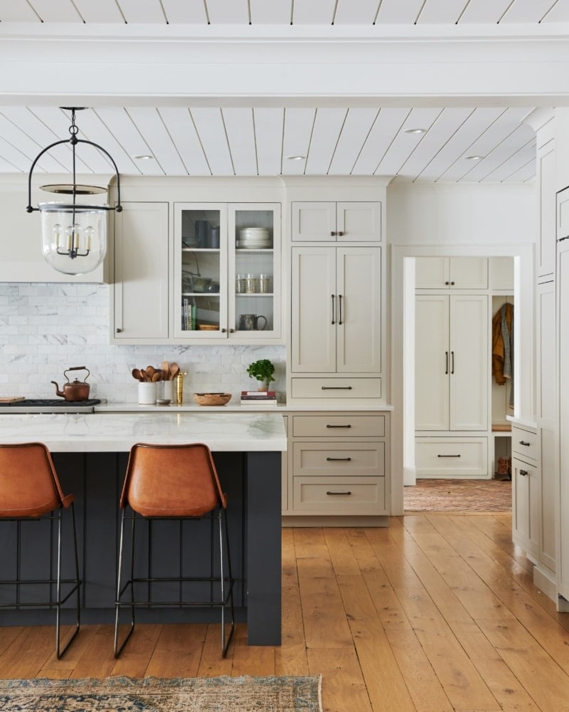 Modern kitchen with revere pewter cabinets and a dark colored accent color on the island