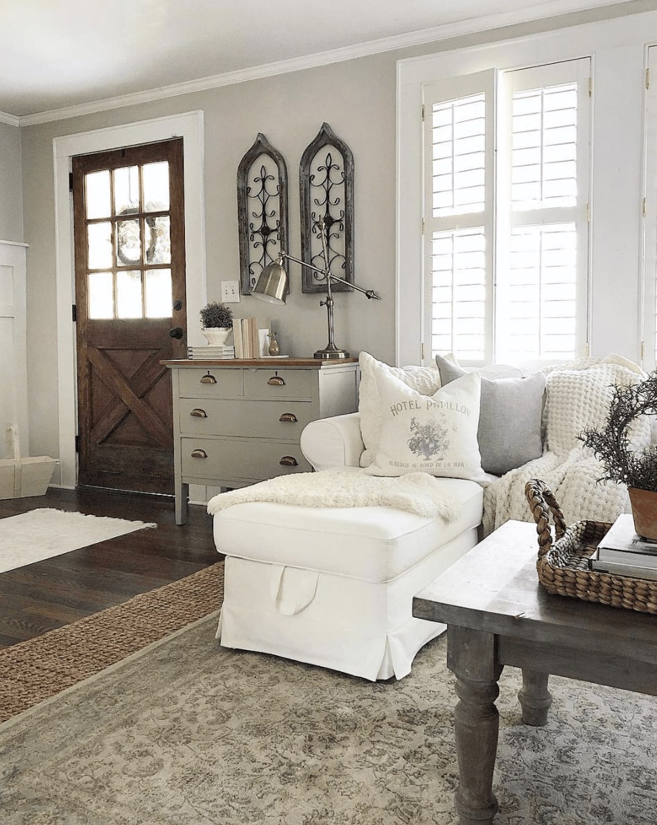 Farmhouse style living room with lots of dark show shows that Agreeable Gray works for all styles