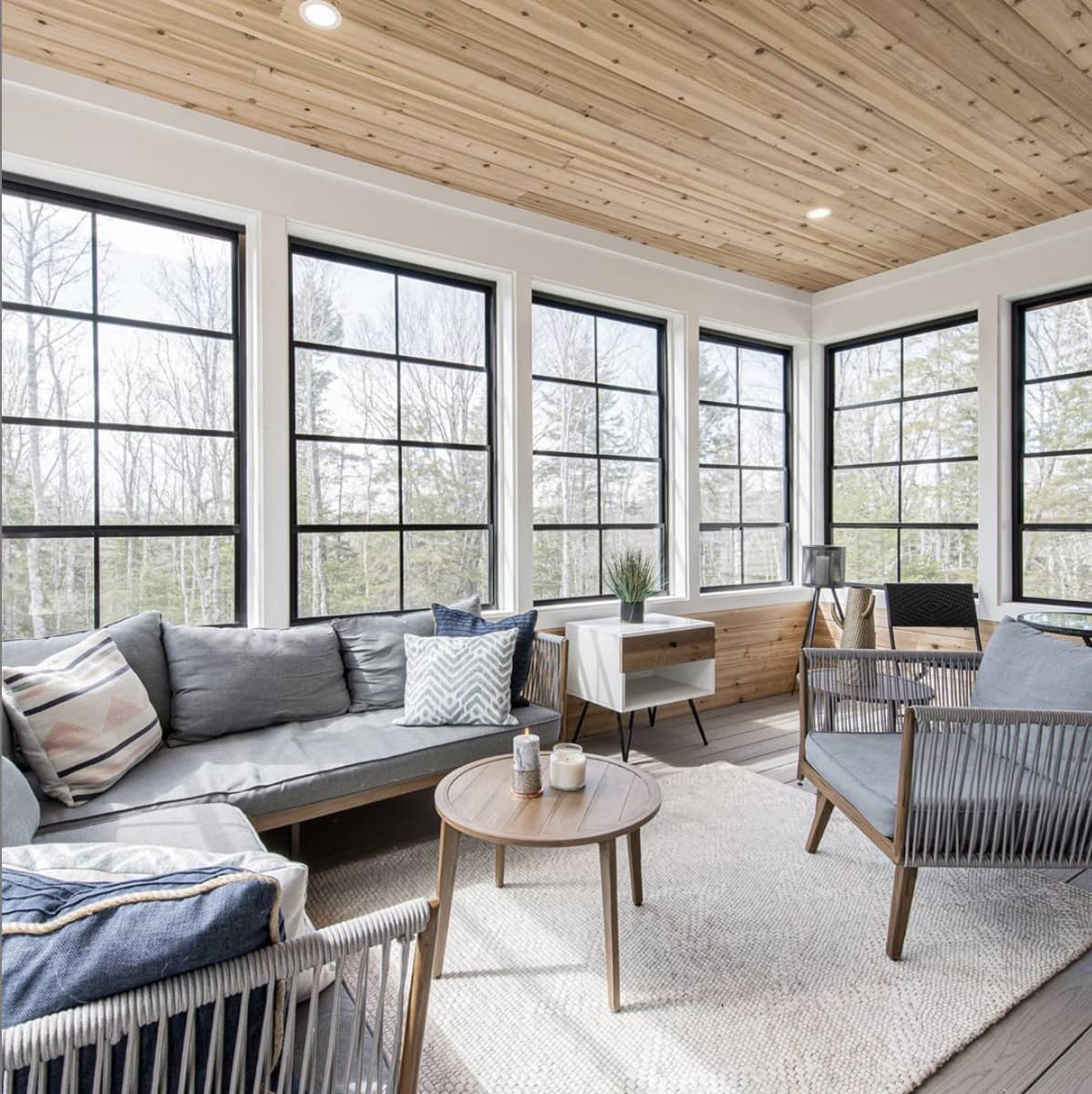 Beautiful porch with wood planked ceilings and black framed windows