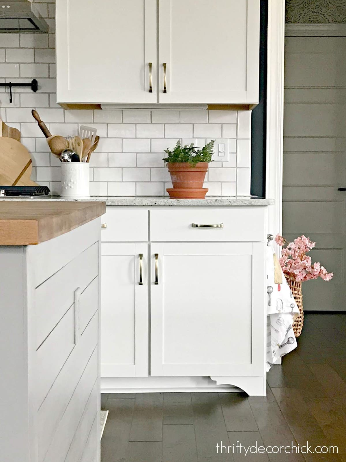 Adding feet to kitchen base cabinets elevates the look of stock cabinets