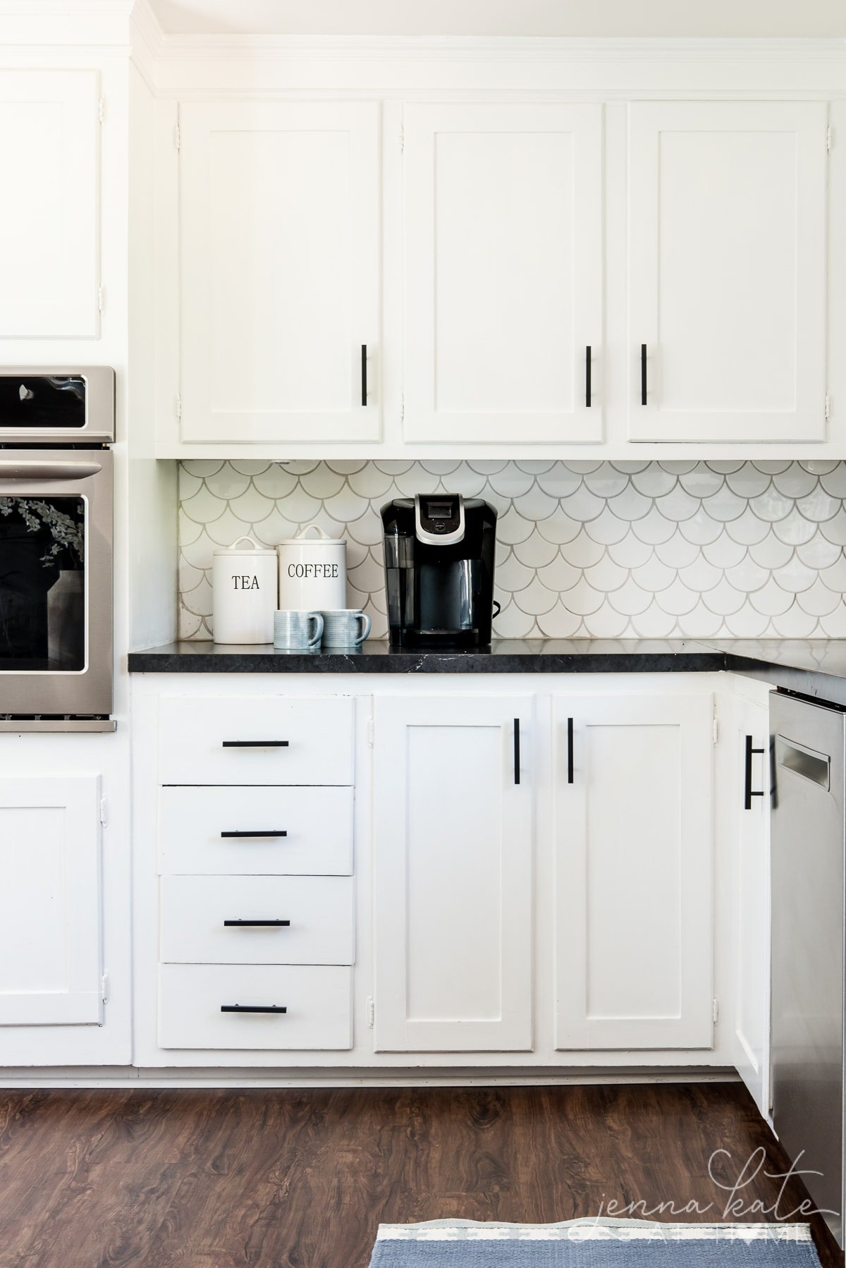 Matte black kitchen pulls on white shaker cabinets